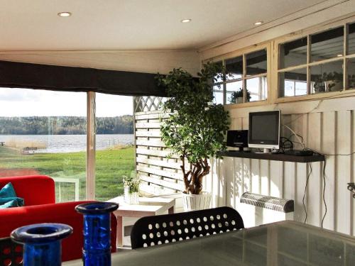 a living room with a couch and a tv and a table at One-Bedroom Holiday home in Lerdala 1 in Lerdala