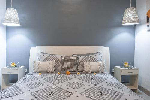 a bedroom with a large bed with two night stands at Villa Mali Legian in Legian