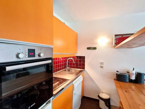 une cuisine avec un évier et une cuisinière four supérieur dans l'établissement Studio confortable à La Daille, ski-in ski-out, balcon sud, 4 pers., proche commerces et navettes - FR-1-518-136, à Val dʼIsère