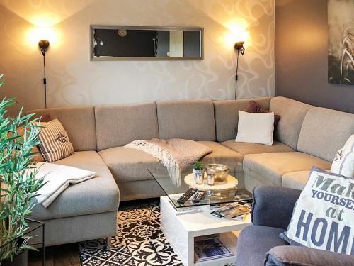 a living room with a couch and a table at 6 person holiday home in AVERØY in Stein