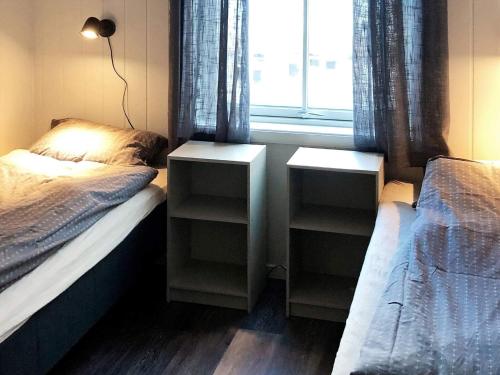 a bedroom with two twin beds and a window at 6 person holiday home in Dyrvik in Dyrvik