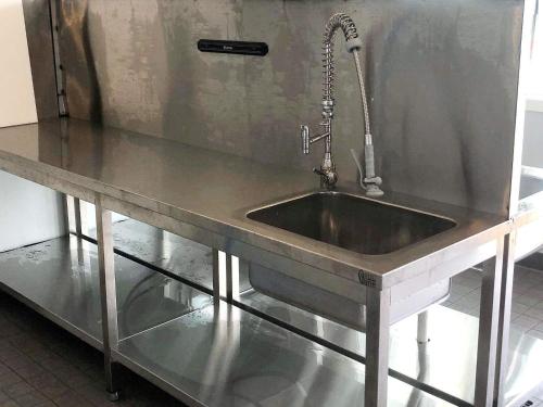 a stainless steel kitchen sink with a faucet at 6 person holiday home in Dyrvik in Dyrvik