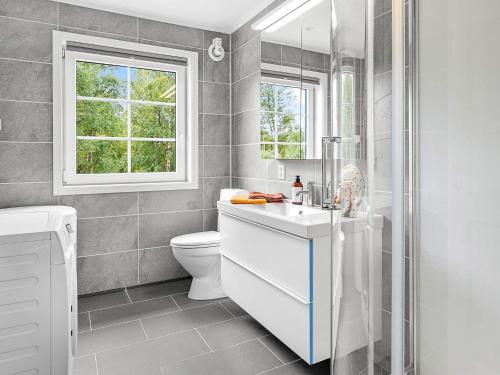 baño con lavabo y aseo y ventana en Holiday home Bindalseidet, 