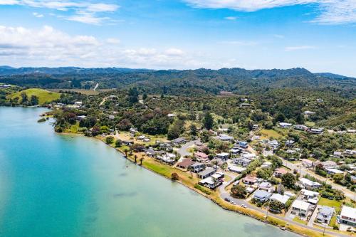 an aerial view of a town next to a river at Waterfront Sunsets Studio in Ngunguru