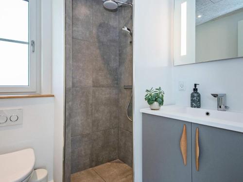 a bathroom with a shower with a toilet and a sink at 12 person holiday home in Ansager in Ansager