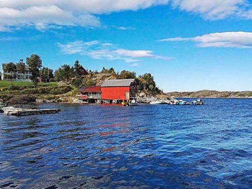a house on the shore of a body of water at 15 person holiday home in Flatanger in Stokke