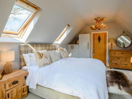 a bedroom with a large bed and a window at Treetops - Uk38735 in Barlow