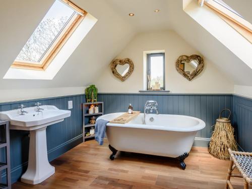 a bathroom with a white tub and a sink at Treetops - Uk38735 in Barlow