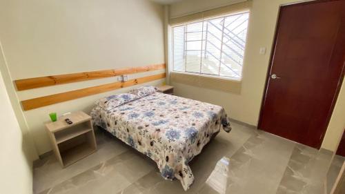 a small bedroom with a bed and a window at La Posada de Pepe in Piura