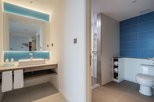 a bathroom with a sink and a toilet at Holiday Inn Express Nanning Jiangnan, an IHG Hotel in Nanning