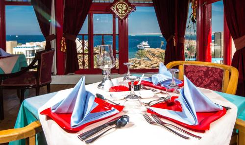a table with red and blue napkins and utensils at Seagull Beach Resort - Families and Couples Only in Hurghada