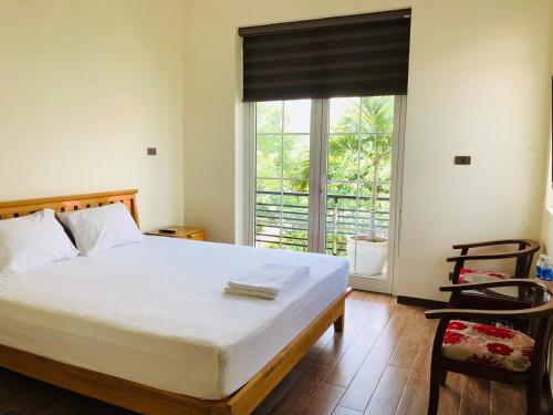 a bedroom with a large bed and a large window at Ninh Binh Brother's Homestay in Ninh Binh