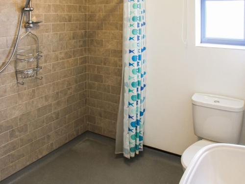 a bathroom with a shower with a toilet and a sink at Willows Barn in Clenchwarton