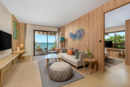 a living room with a couch and a table at Holiday Inn Resort Samui Bophut Beach by IHG in Bophut 