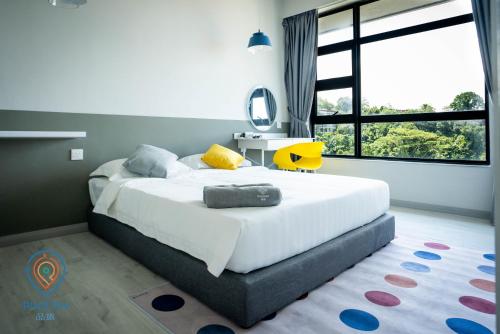 a bedroom with a large bed and a large window at Jesselton Quay by Pinstay in Kota Kinabalu