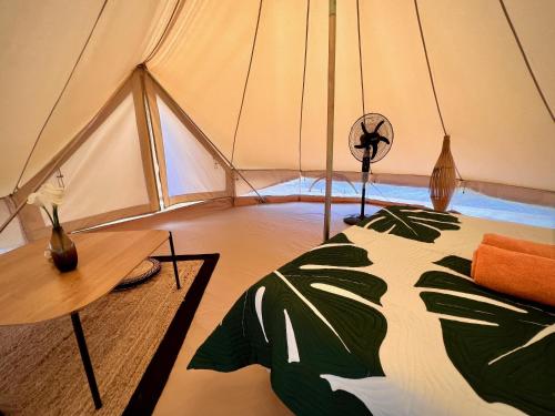 a bedroom with a bed in a tent at Va'a i te Moana in Avatoru
