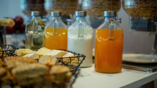 a table with bottles of orange juice and bread at Holiday Inn Express Chennai OMR Thoraipakkam by IHG in Chennai
