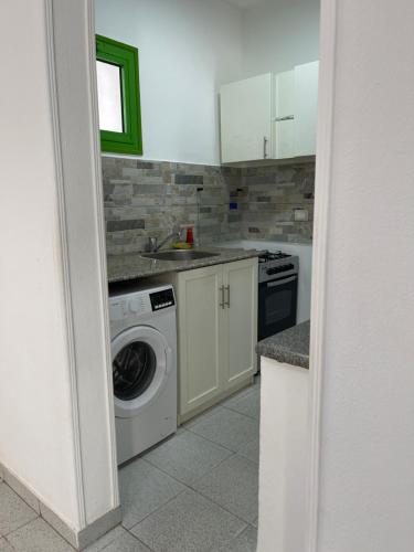 a kitchen with a washing machine and a sink at City Center Apartment - Neama Bay in Sharm El Sheikh