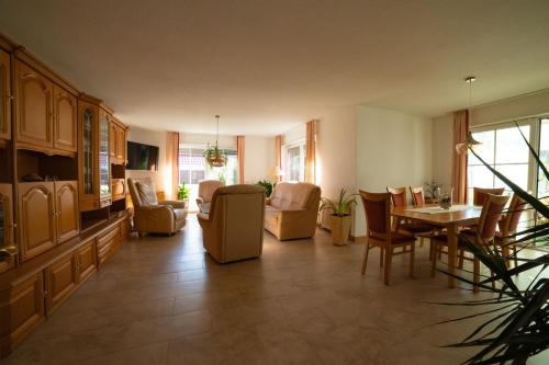 a living room with a table and chairs at Schönes & gemütliches Ferienhaus nahe der Nordsee in Schortens