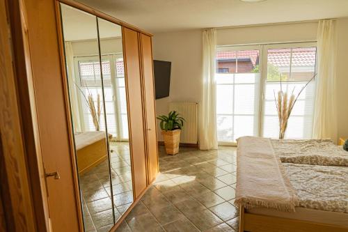 a bedroom with a bed and a large mirror at Schönes & gemütliches Ferienhaus nahe der Nordsee in Schortens