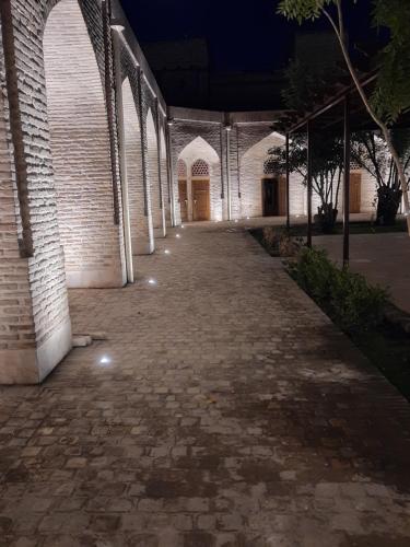 an empty hallway of a building at night at Marhaba boutique Madrasah 15th-16th century in Bukhara