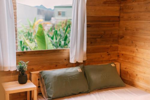 a room with a couch in front of a window at Lacasa home&coffee Mộc Châu in Mộc Châu