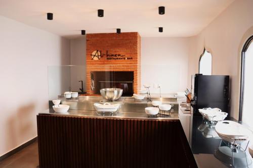 a kitchen with a large counter with a fireplace at Suites Layfer, Córdoba, Veracruz, México in Córdoba