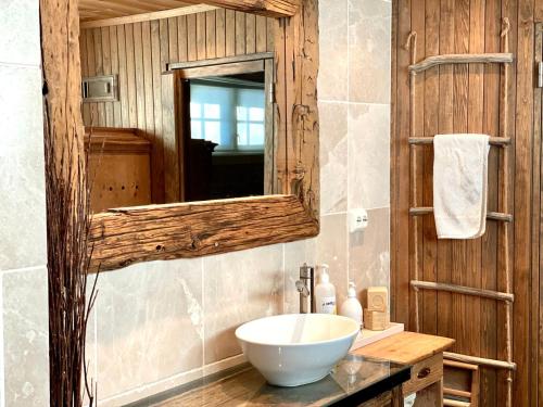 a bathroom with a sink and a mirror at Vasethytta - cabin with a lovely view in Brujordet