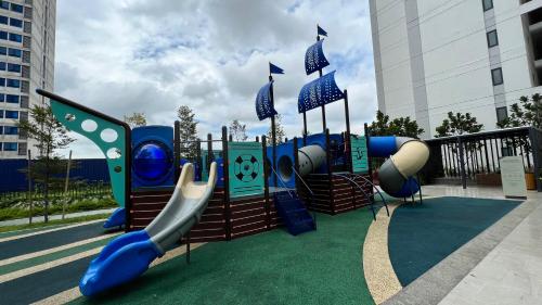 a playground with a slide in a park at Klia Horizon Suite Kota Warisan in Sepang