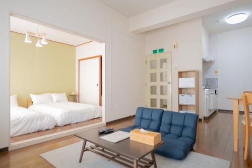 Ένα ή περισσότερα κρεβάτια σε δωμάτιο στο RIVER WEST HIROSHIMA