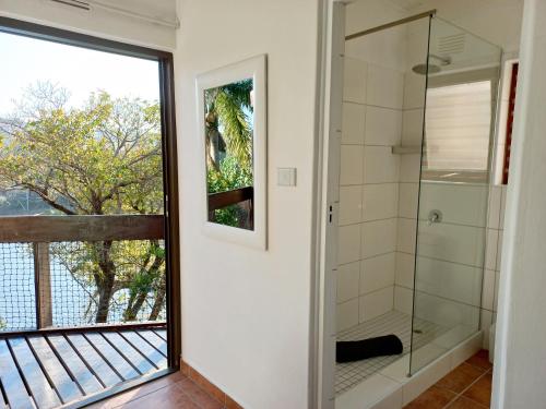 a bathroom with a shower and a window at 2 Bedroom Lagoon Villa Sanlameer Estate, with water tank & UPS in Marina Beach