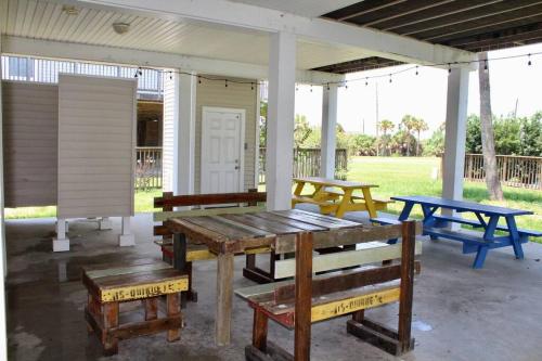 a group of picnic tables and benches on a patio at Enjoy Our Ocean Oasis in Galveston