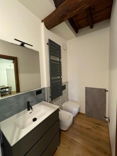 a bathroom with a sink and a toilet at La dimora della Giudecca - 13 in Cuneo