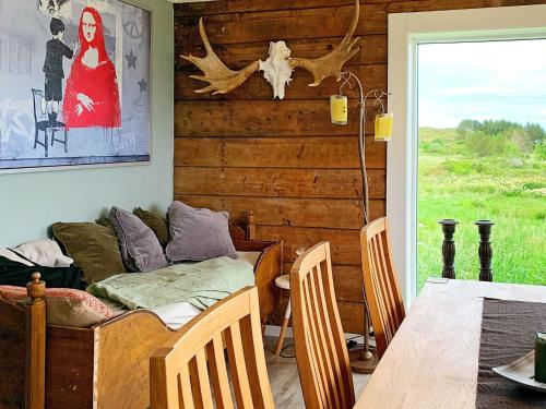 a dining room with a couch and a table at 8 person holiday home in Bølandet-By Traum in Røyra