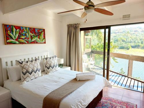 a bedroom with a bed and a large window at 2 Bedroom Lagoon Villa Sanlameer Estate, with water tank & UPS in Marina Beach