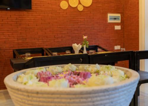 a basket filled with flowers on a table at Angkor Rithy Residence team in Siem Reap