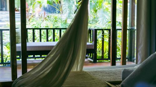 a hammock in a room with a porch at ONAYA Bali Resort - Adults Only in Uluwatu