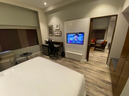 a hotel room with a bed and a flat screen tv at Country Inn & Suites By Radisson Jammu in Jammu
