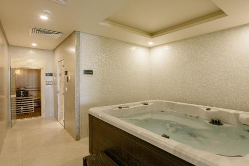 a bathroom with a large tub in a room at Sunset Jeddah in Jeddah