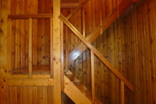 an attic staircase in a wooden cabin at Kihelkonna Pastorate Guesthouse in Kihelkonna