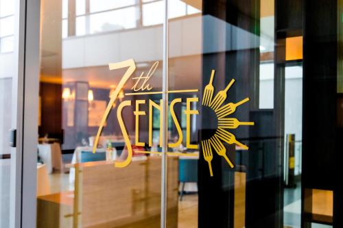 a glass door with a sign that reads the first at The Quorum in Lusaka