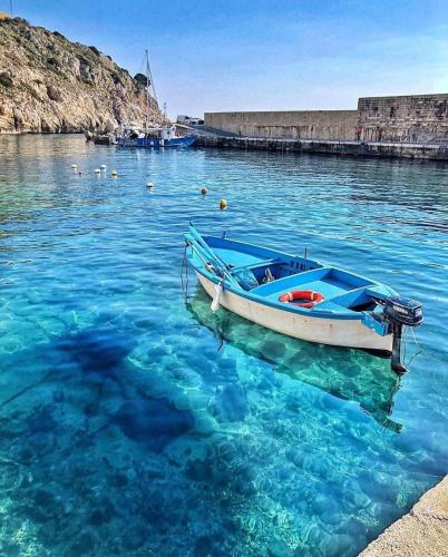 a boat sitting in the water near a dock at Villaelena in Marittima