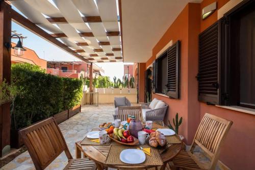 a table with a bowl of fruit on a patio at Villaelena in Marittima