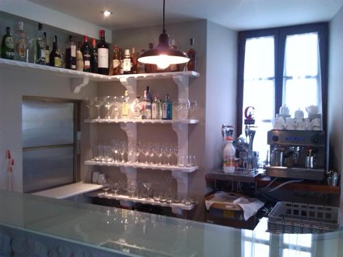 a bar with a bunch of glasses on shelves at Hotel Villadesella in Ribadesella