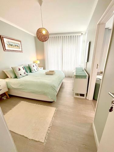a bedroom with a bed and a large window at 706 Portico in Cape Town