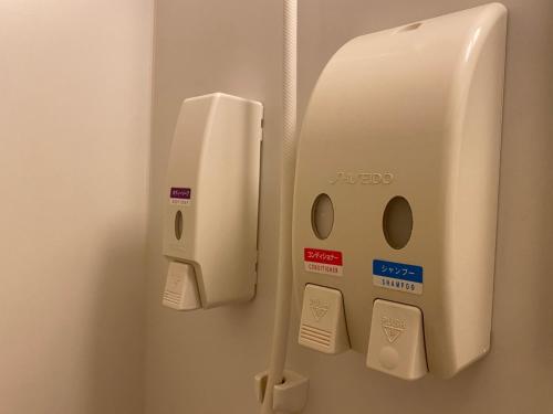 a soap dispenser is attached to a wall at Az Inn Fukui - Vacation STAY 65935v in Fukui