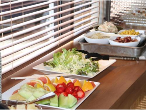 a buffet with several plates of food on a counter at Az Inn Fukui - Vacation STAY 65935v in Fukui