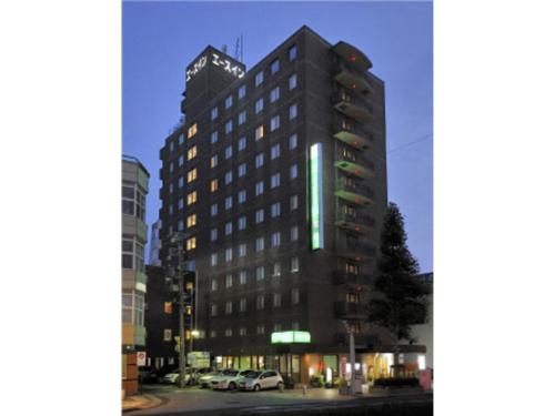a tall building on a city street at night at Az Inn Fukui - Vacation STAY 65935v in Fukui