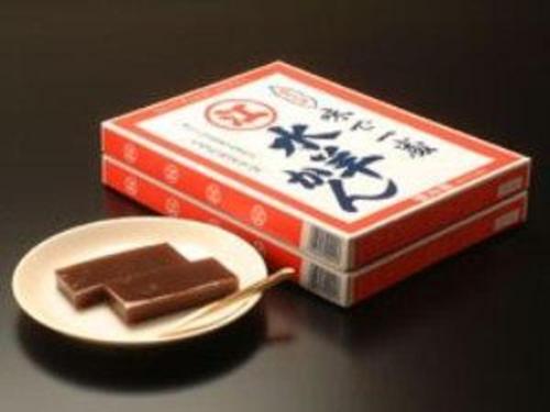 a box of chocolate next to a plate with a fork at Az Inn Fukui - Vacation STAY 65935v in Fukui