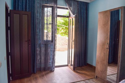an open door in a room with blue walls at RiverSide Guest House in Dilijan